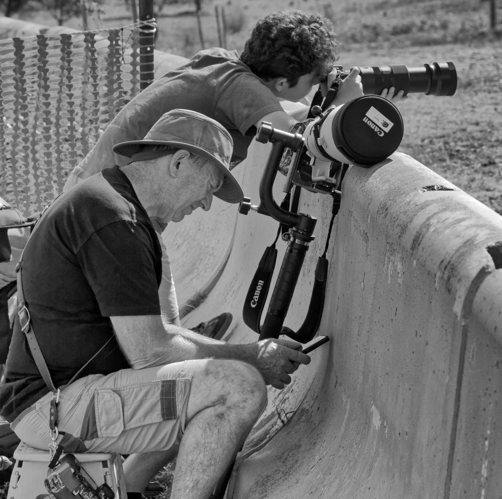 A pro and amateur photographer, waiting for the event to begin