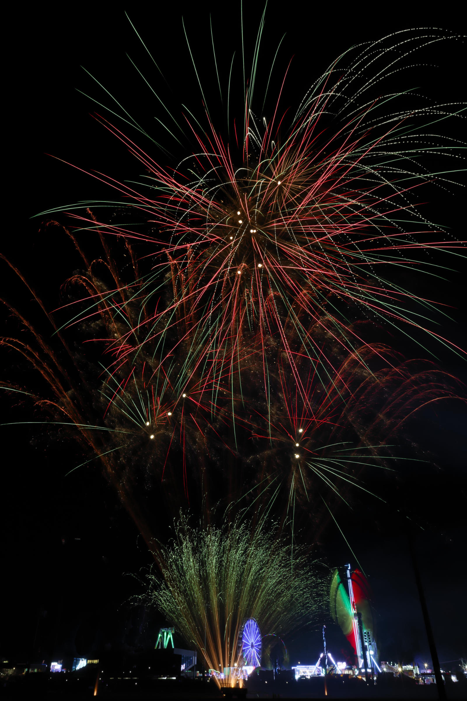 Fireworks and carnival rides showing intermediate exposure duration